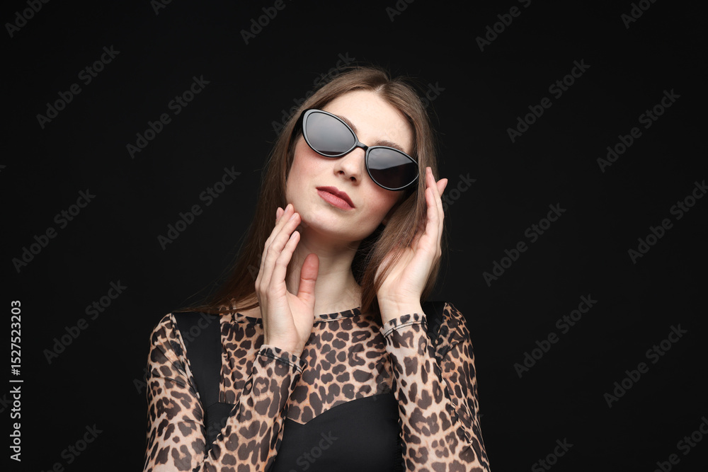 Obraz premium Fashionable portrait of beautiful woman in stylish outfit on black background