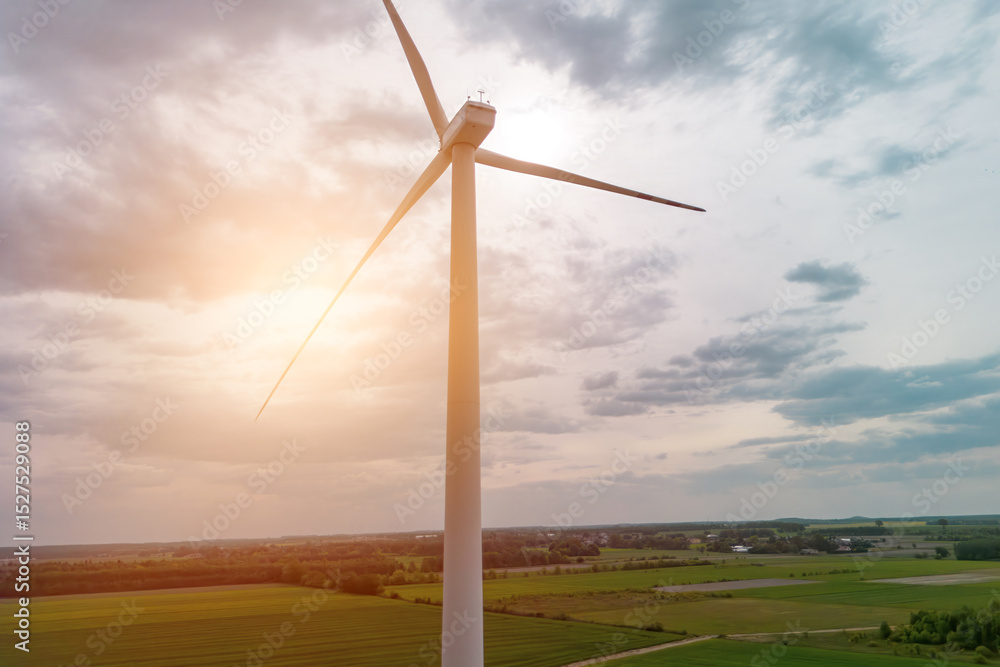 Obraz premium Clean energy windmill under summer clouds