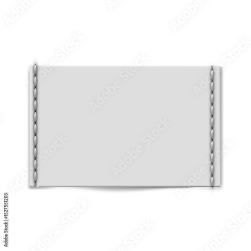 Rectangular textile, horizontal label with stitches along the edges.