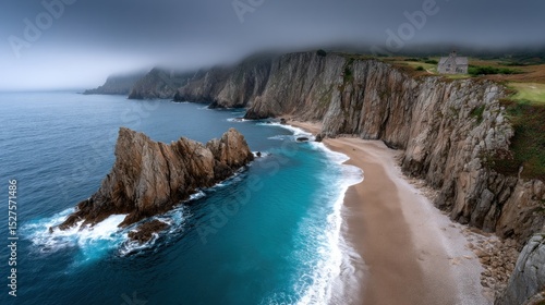 Majestic cliffs rise above a serene beach with turquoise waters and rocky outcrops. Light fog envelops the area, creating a mysterious atmosphere in this tranquil coastal landscape