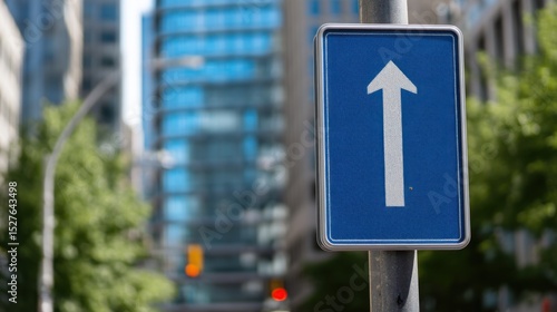 Blue rectangular one way street sign white arrow