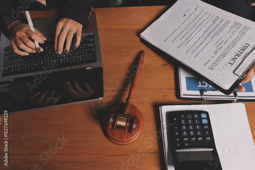 Attractive young lawyer in office Business woman and lawyers discussing contract papers with brass scale on wooden desk in office. Law, legal services, advice, Justice and real estate concept.