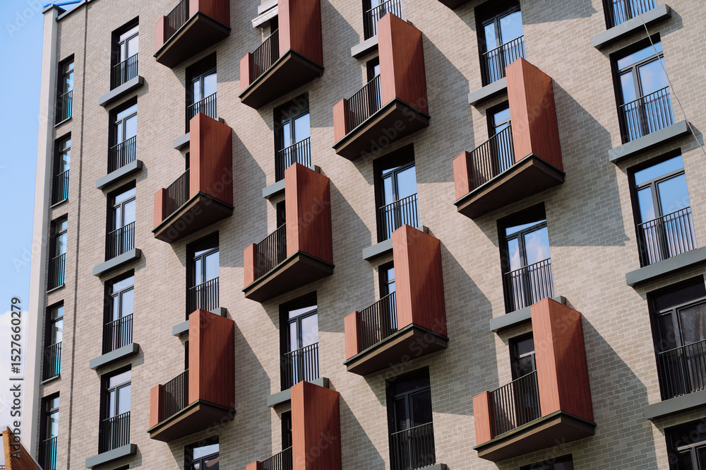 Fototapeta premium modern apartment building with geometric balconies creating visual pattern. urban residential architecture highlighted by striking design, emphasizing contemporary city living and style