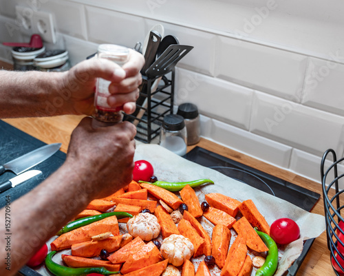 Colorful Roasted Vegetables with Senior Hands Preparing a Healthy Meal
