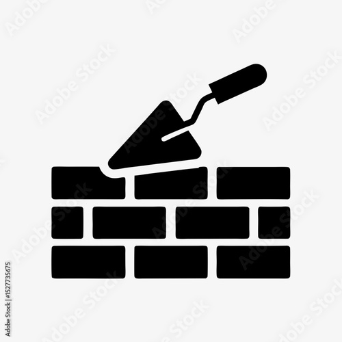 Brick wall construction icon with trowel silhouette on white background
