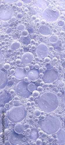 A close-up view of bubbles in a liquid, showcasing various sizes and a soft purple background, creating an abstract and soothing visual effect.
