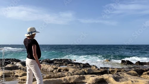 Woman Enjoying Ocean Views on Sliema's Picturesque Coast, Malta