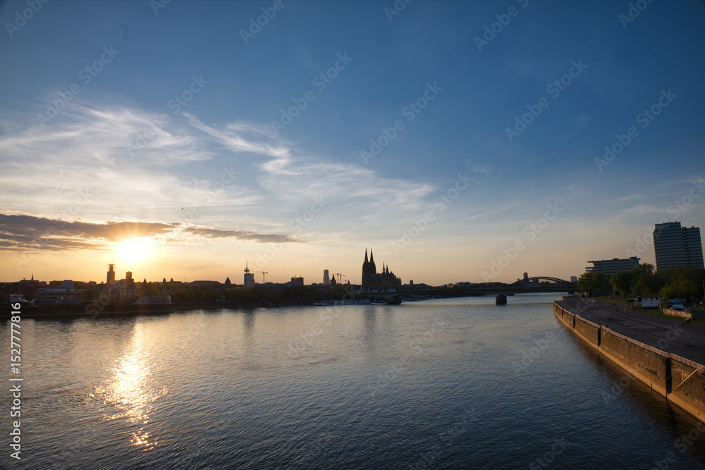 Fototapeta premium Cologne Skyline and Rhine River at Sunset with Cologne Cathedral Silhouette
