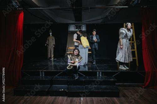 Fotografie Young actors engaged in a dramatic performance on a stage setting