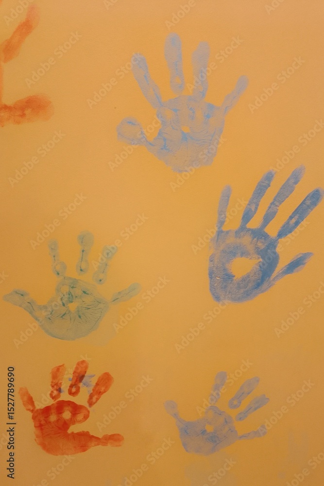 Fototapeta premium colorful hand prints on yellow wall 