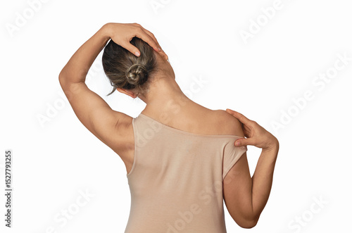Bild auf Leinwand Woman in beige shirt with bare shoulders relaxes neck, stretching neck muscles