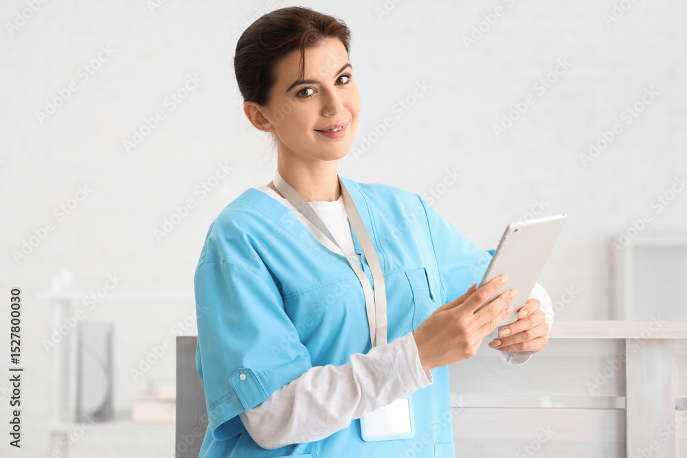 Female medical intern with tablet computer in clinic Female medical intern with tablet computer in clinic