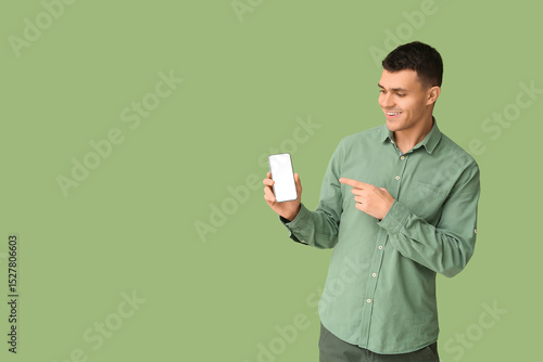 Young man pointing at mobil...