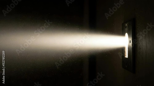 Light beam shining through keyhole in dark environment  