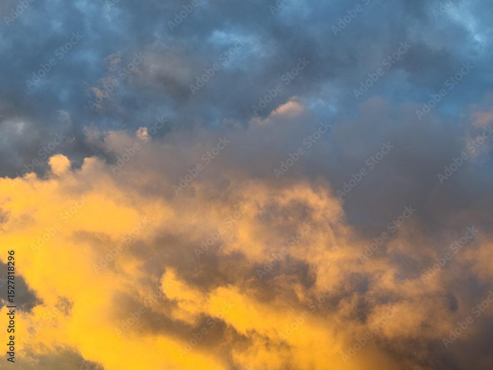 Golden light reflecting on dark storm clouds Golden light reflecting on dark storm clouds