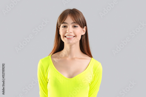 Young woman smiling on ligh...