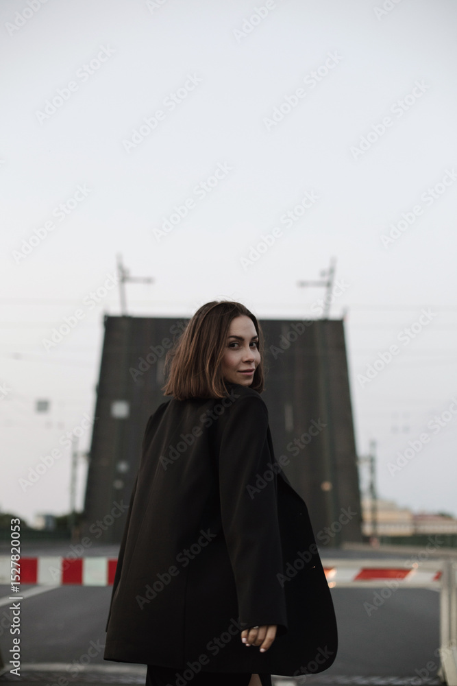 Fototapeta premium young woman walking in the street. Drawbrige