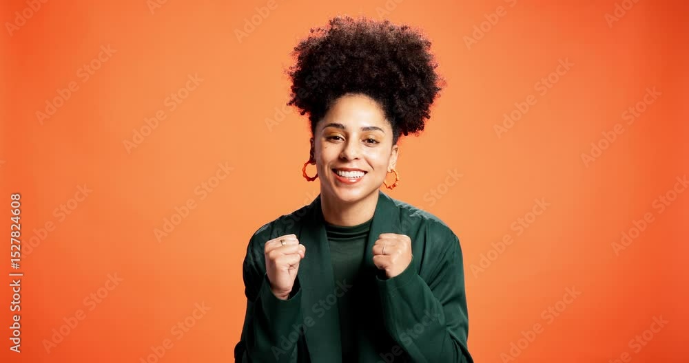 Success, fist pump and face with woman in studio for cheering, news and announcement. Promotion, giveaway and celebration with person on orange background for reward, achievement and yes gesture Success, fist pump and face with woman in studio for cheering, news and announcement. Promotion, giveaway and celebration with person on orange background for reward, achievement and yes gesture