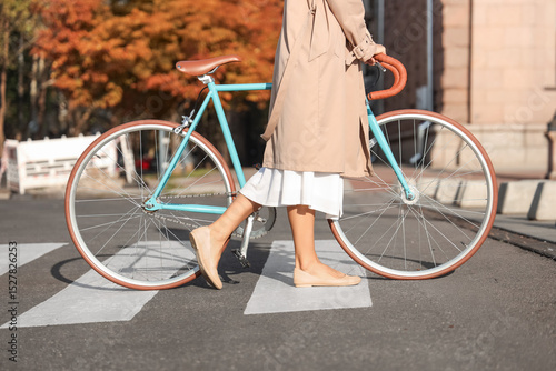 Young woman with bicycle wa...