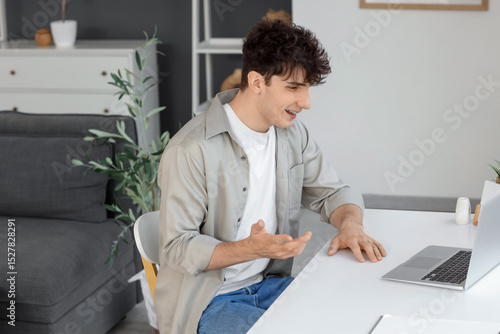 Young man video chatting wi...