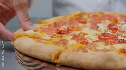 Grabbing pepperoni pizza slice, melted cheese