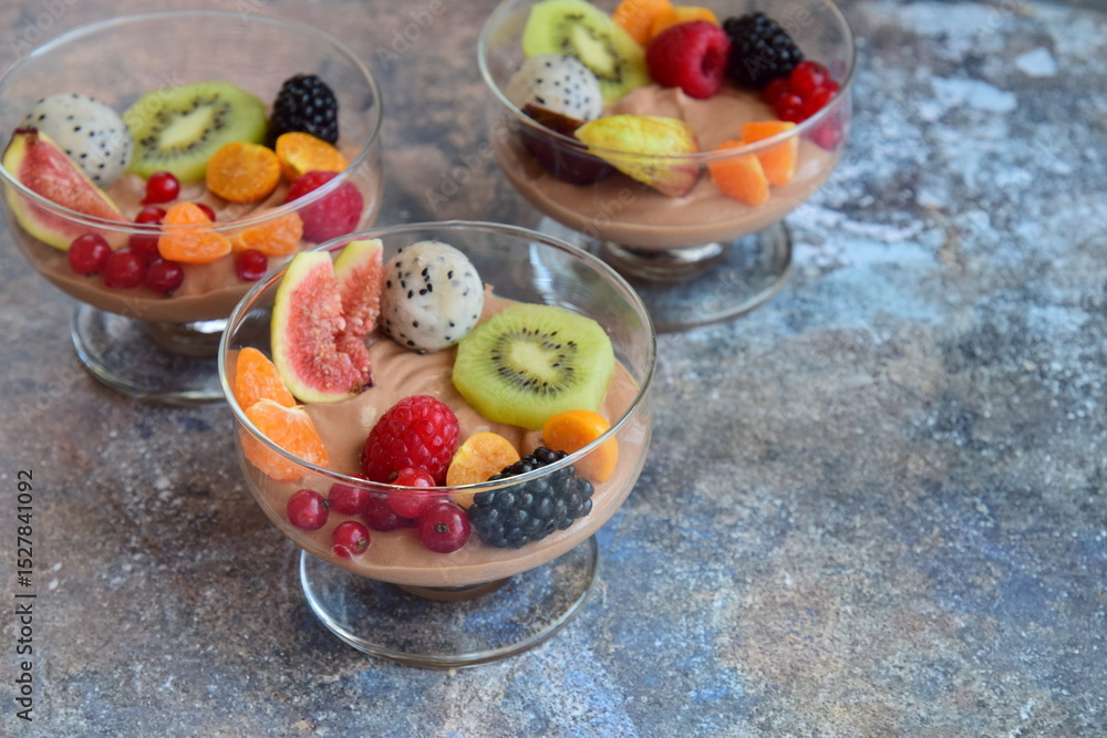 Silken tofu chocolate mousse dessert with mixed fresh fruits ( kiwi, dragon fruit, raspberry, blackberry, fig, orange, red currant, physalis). Vegan dessert Silken tofu chocolate mousse dessert with mixed fresh fruits ( kiwi, dragon fruit, raspberry, blackberry, fig, orange, red currant, physalis). Vegan dessert