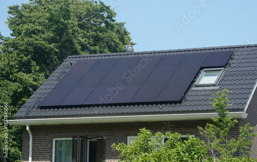 Modern house rooftop installation of solar panels generating renewable energy for green living