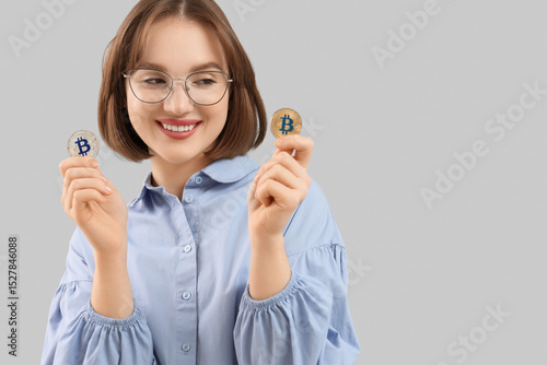 Young woman with bitcoins o...