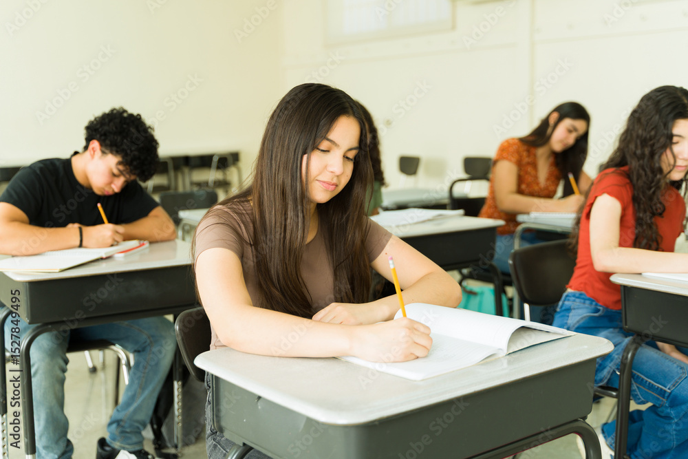 Fototapeta premium Focused high school students taking exam in classroom