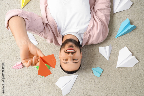 Young man with paper planes...