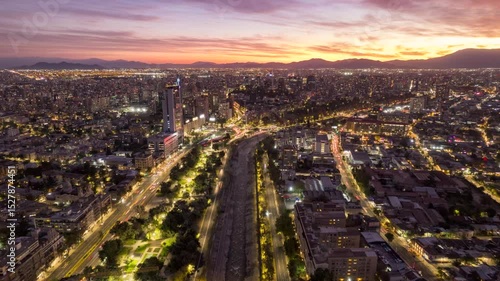 Wallpaper Mural SANTIAGO, CHILE – APRIL, 25, 2024. Dynamic hyperlapse: Drone advances westward over Mapocho River. Captures vibrant sunset, city lights, urban sprawl, and surrounding mountains. Stunning aerial view Torontodigital.ca