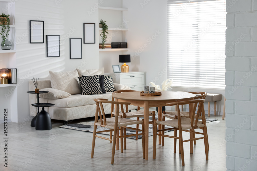Table, chairs and comfortable sofa indoors. Interior design Table, chairs and comfortable sofa indoors. Interior design