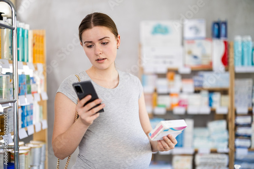 Photos Pregnant woman checks expiration dates of pills using smartphone