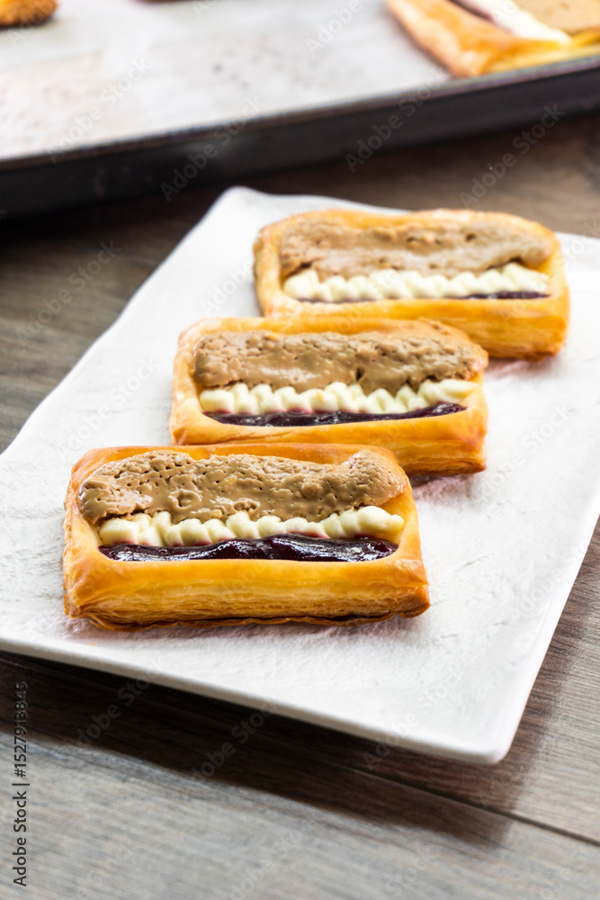 Fototapeta premium Puff pastry tarts with cream cheese, cherry jam, peanut butter. Dessert. pastry