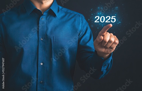 Man in blue shirt touches 2025, futuristic concept