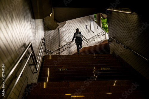 Wall Mural Business Woman Climbing Subway Steps in Tokyo, Japan