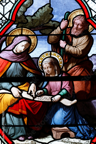 Saint-Pierre church.  Stained glass. Saint Anne teaching the young Virgin to read.  Chateau Chalon. France.