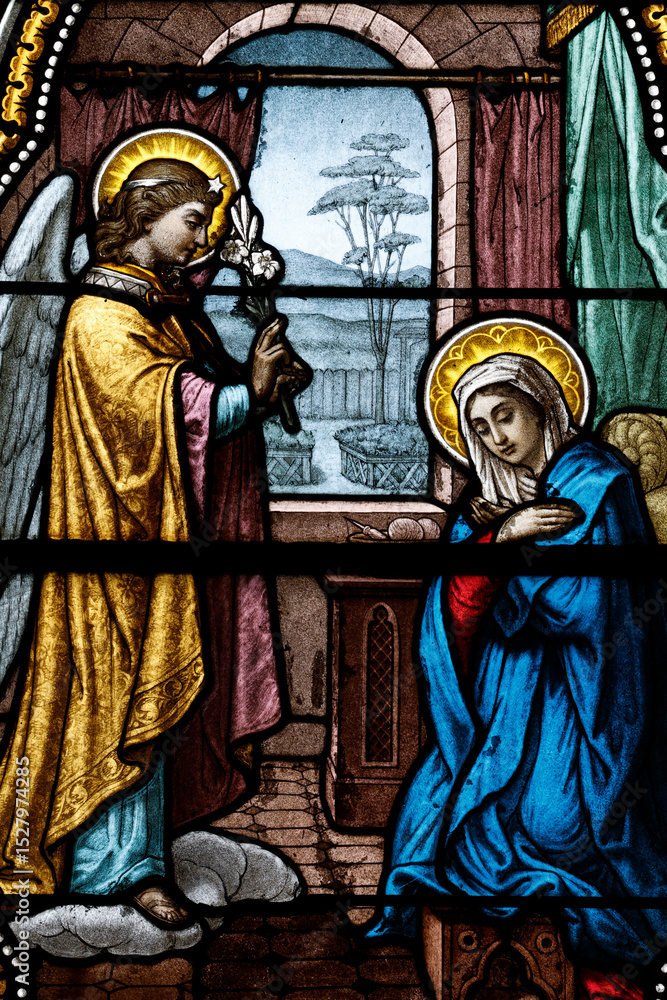 Fototapeta premium Saint Germain church. Stained glass. The Annunciation is the announcement by the angel Gabriel to the Virgin Mary that she will become the mother of Jesus. Saint-Germain du Bois. France.