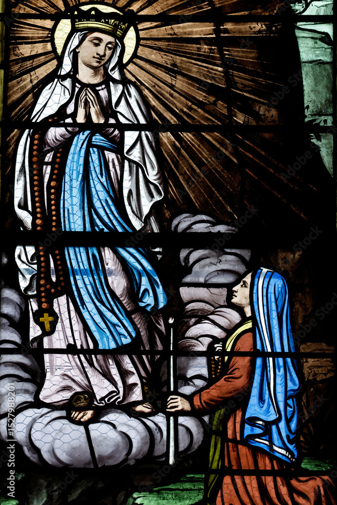Obraz premium Saint Pierre church. Stained glass. Our Lady of Lourdes. Toucy. France.