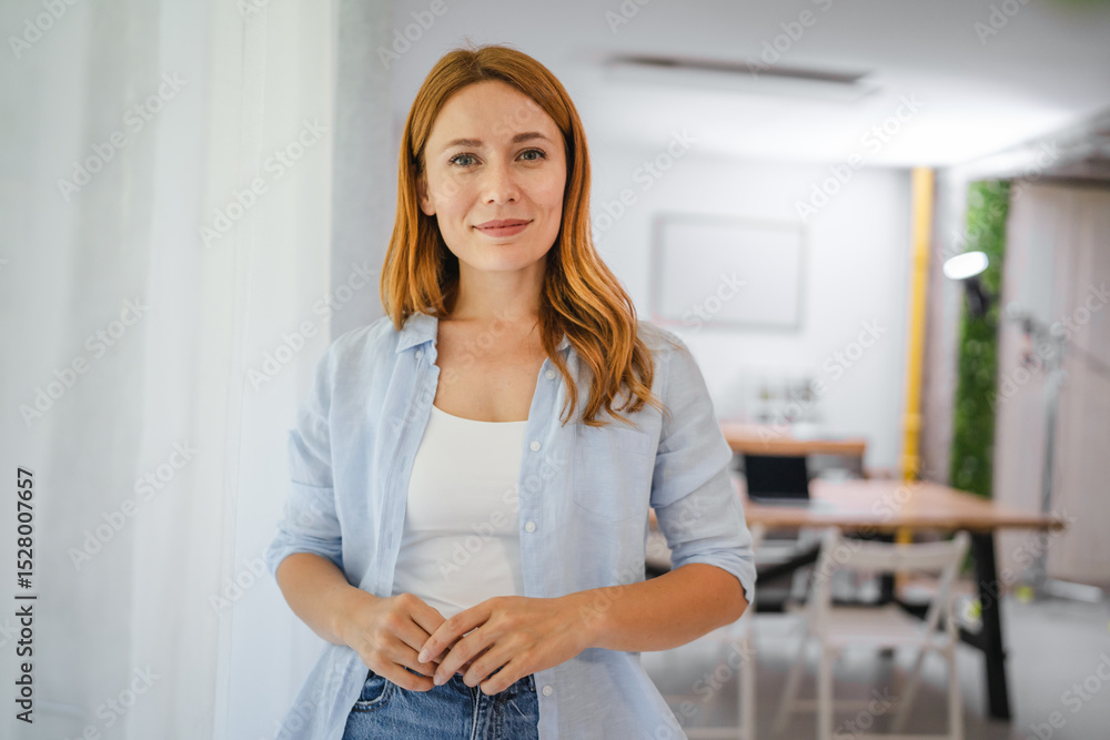 Portrait of happy redhead woman smile and pose in home setting Portrait of happy redhead woman smile and pose in home setting