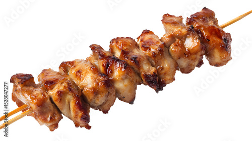 A skewer of chicken is sitting on a white background. The chicken is cooked and has a golden brown color