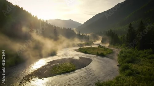 Misty river winding through a valley at dawn