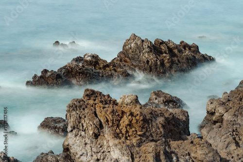 Waves crashing on rocks at the beach