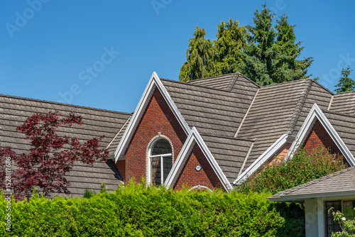 Wallpaper Mural Top of grey stucco luxury house with shingle roof, green trees and nice windows in Spring in Vancouver, Canada, North America. Day time on May 2025. Torontodigital.ca