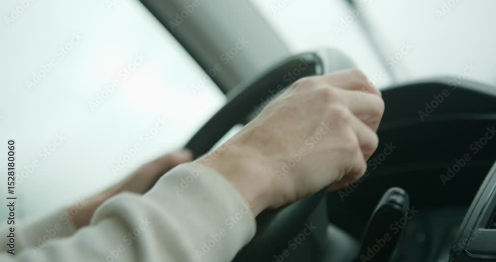 A close-up of hands on the gearshift lever
of an adult woman, shifting gears. AND THE CAMERA MOVES FROM THE LEVER TO THE STEERING WHEEL. A close-up of hands on the gearshift lever
of an adult woman, shifting gears. AND THE CAMERA MOVES FROM THE LEVER TO THE STEERING WHEEL.