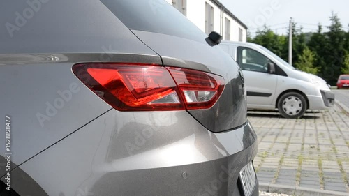Man closes car boot trunk on parking 