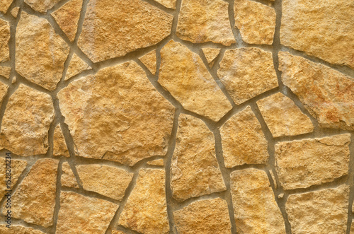 New colorful stone wall closeup in sunny day