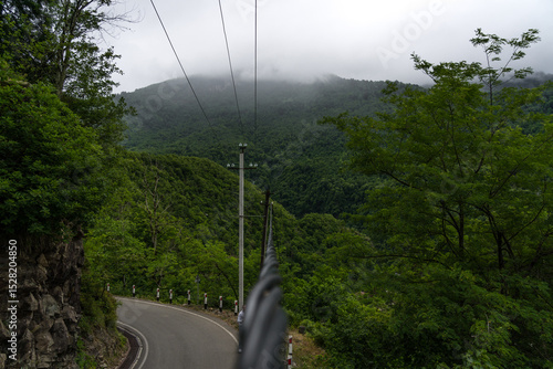 Power line cable with mountain view in clouds Georgia