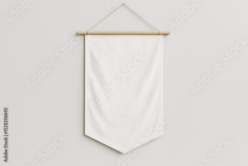 Blank white pennant banner hanging on light grey wall
