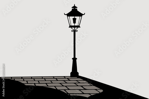 Old antique street lamp post illuminating the city street at dusk